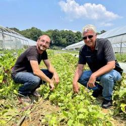 SCORE mentor with client at his farm